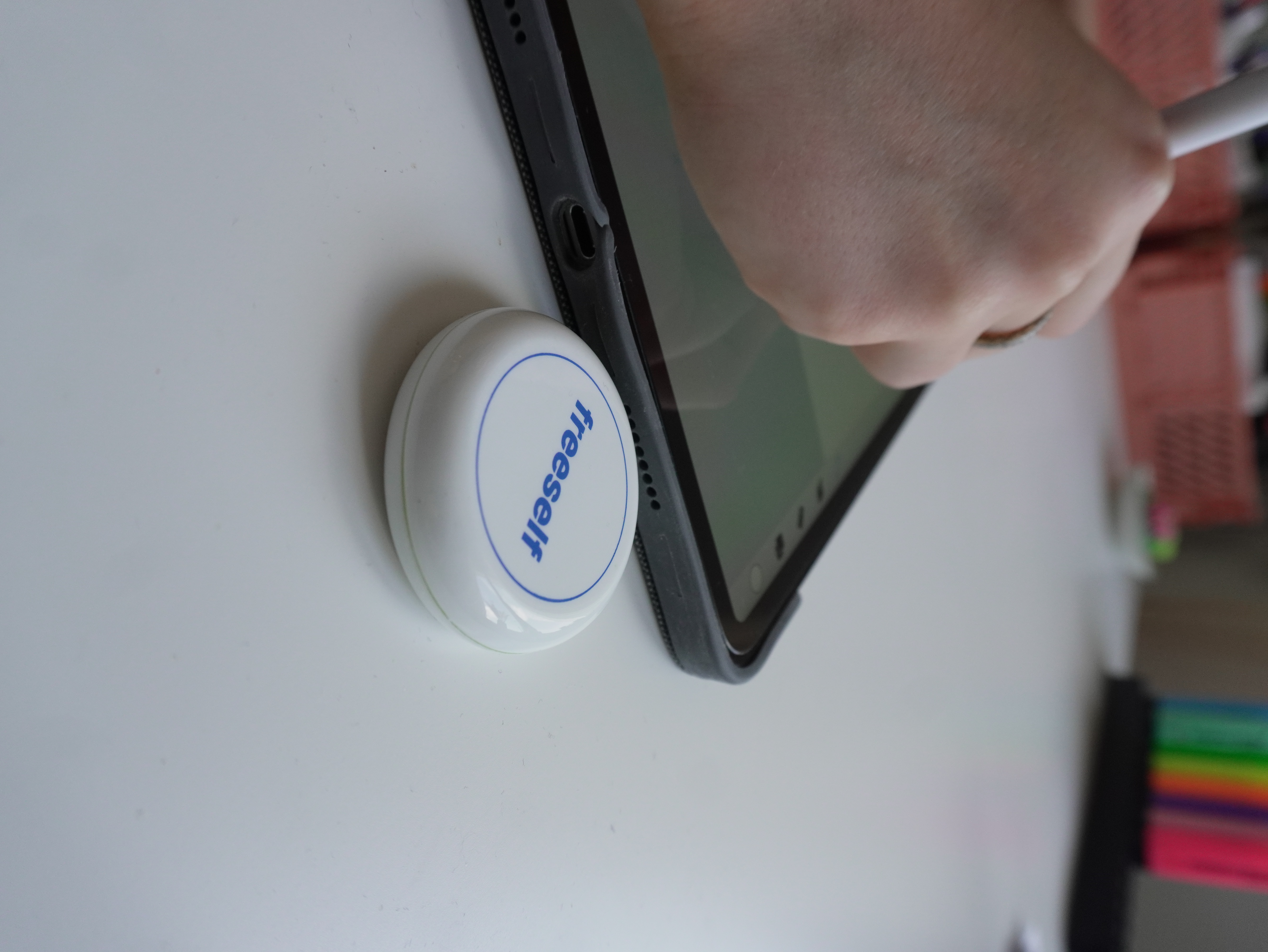 freeself Tag on a desk next to an iPad